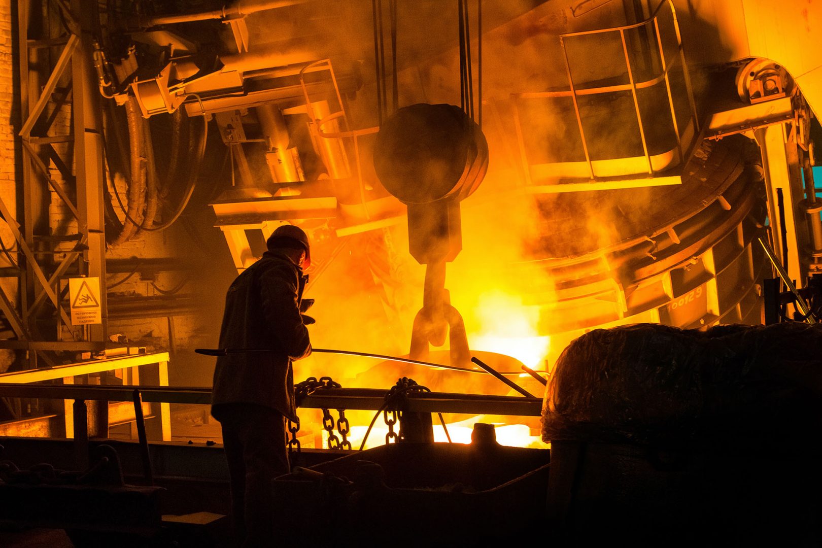 a guy pouring metals in a foundry setting