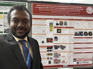 Man in front of poster